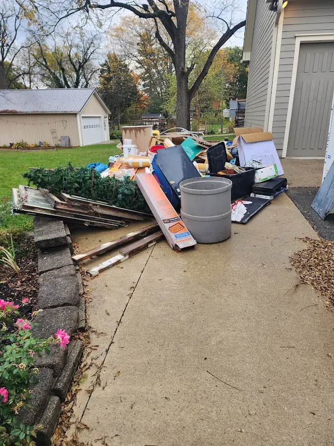 Dumpster being loaded with debris for Estate Cleanout Dumpster Rental in Easton